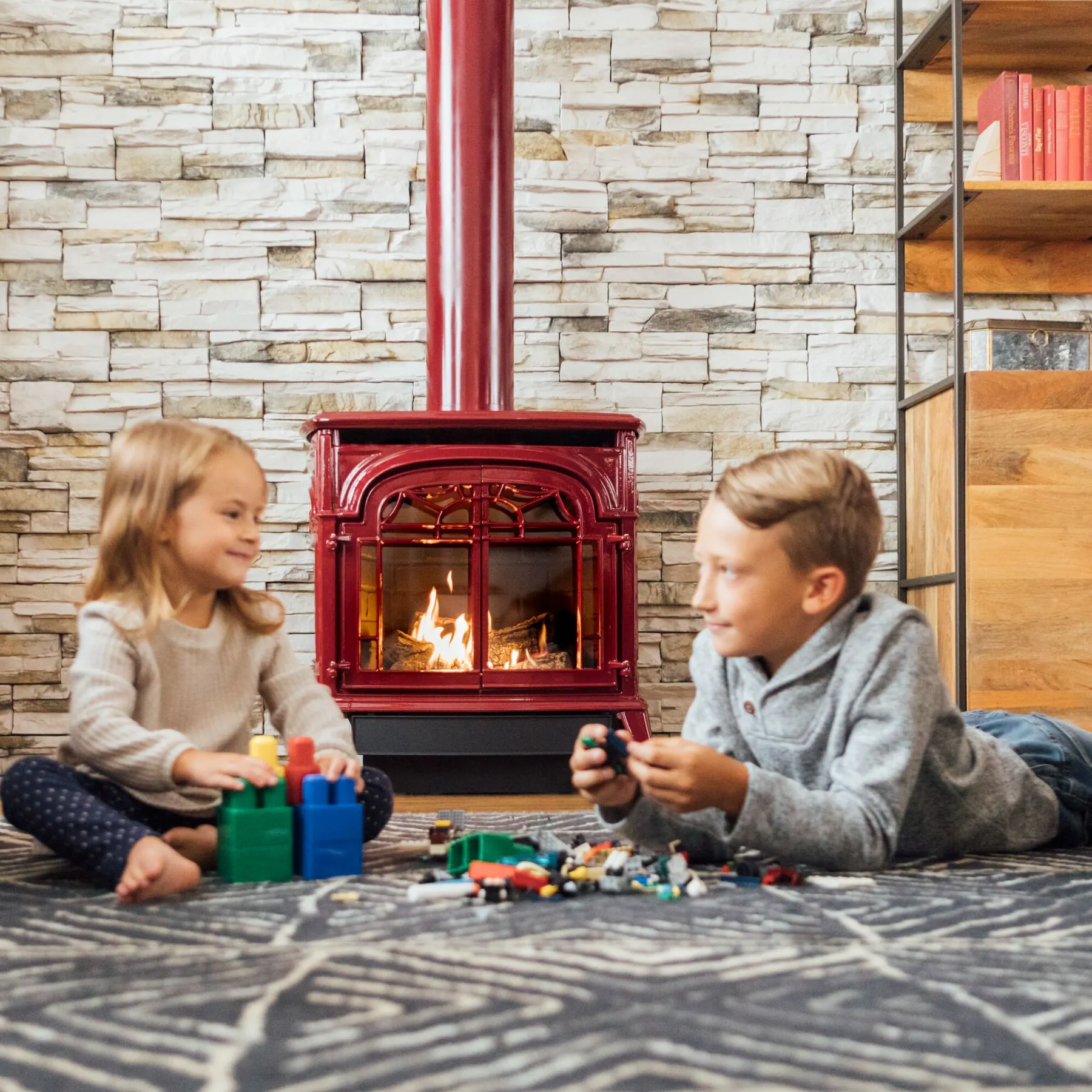 A homeowner adjusting a gas stove from a phone in a bright living room