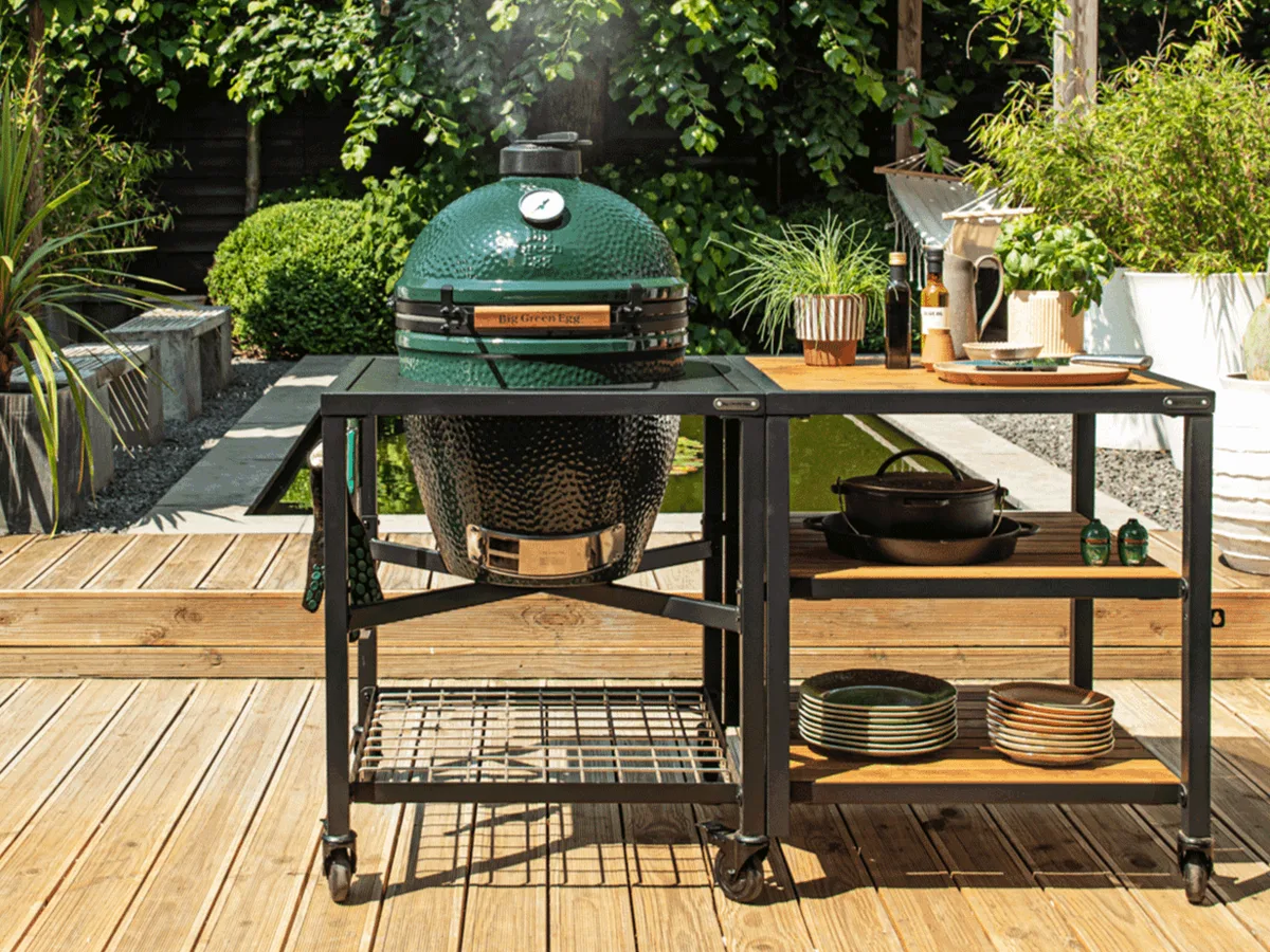 The Large Big Green Egg in a modular nest on a backyard deck