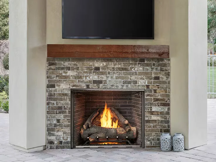 An Outdoor Lifestyles Courtyard 36 outdoor gas fireplace on a patio