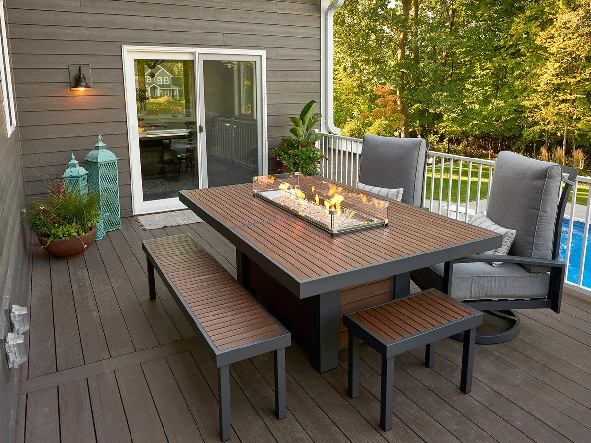 An Outdoor GreatRoom Kenwood gas fire pit table burning on a patio